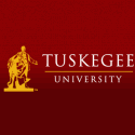 Logo of Tuskegee University on a red background features a golden statue and the university name in bold letters.